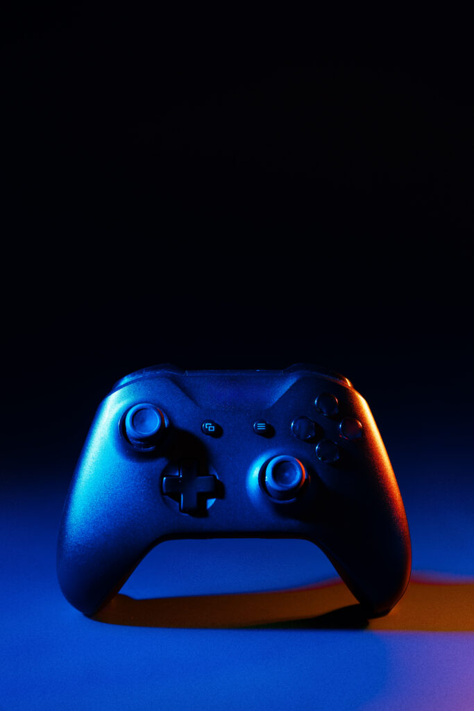 Gaming joystick on black background in neon light