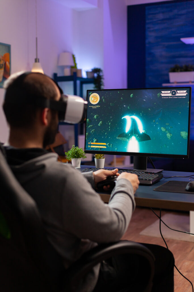 Player man playing video game at powerful computer